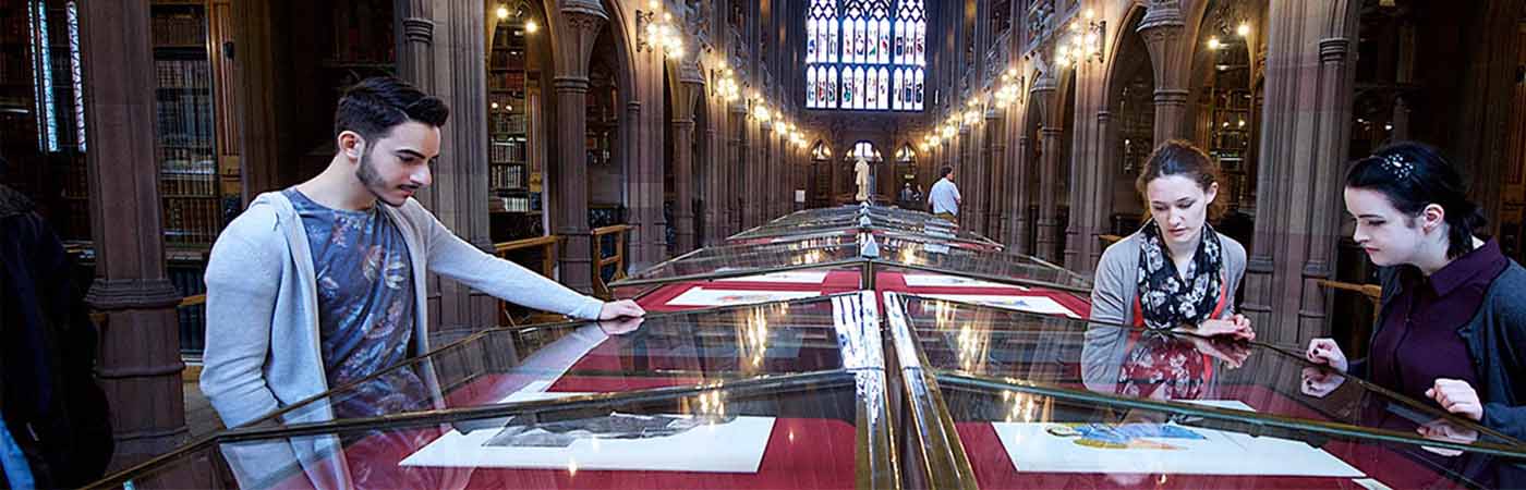 Students looking at display cabinets in the John Rylands library